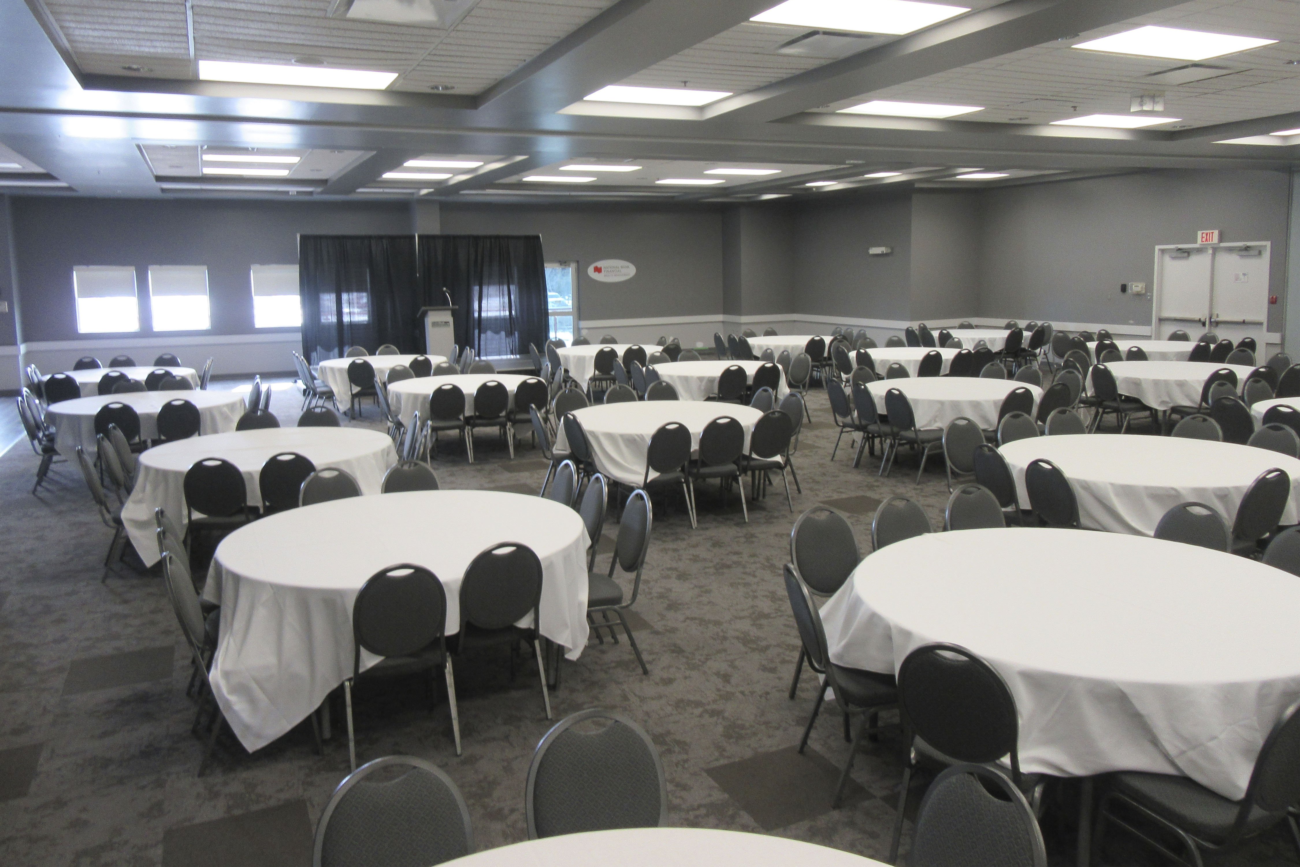 Round tables with table cloths in room